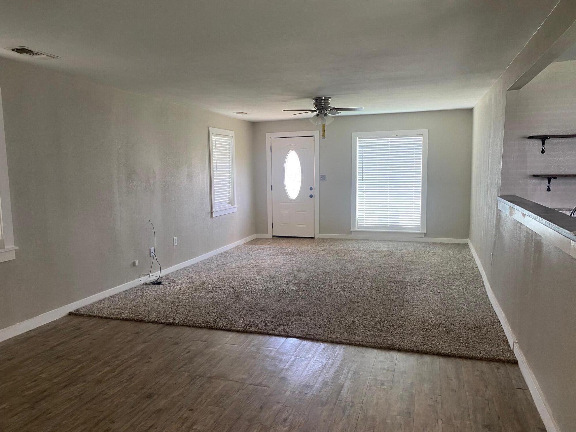 207 East 5th Street Sundown, TX 79372 - Photo 2 of 13 an empty room with windows and closet