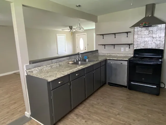 a kitchen with a sink stove and cabinets