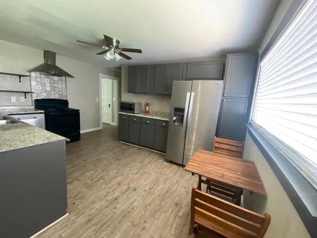a kitchen with wooden cabinets and a stove top oven