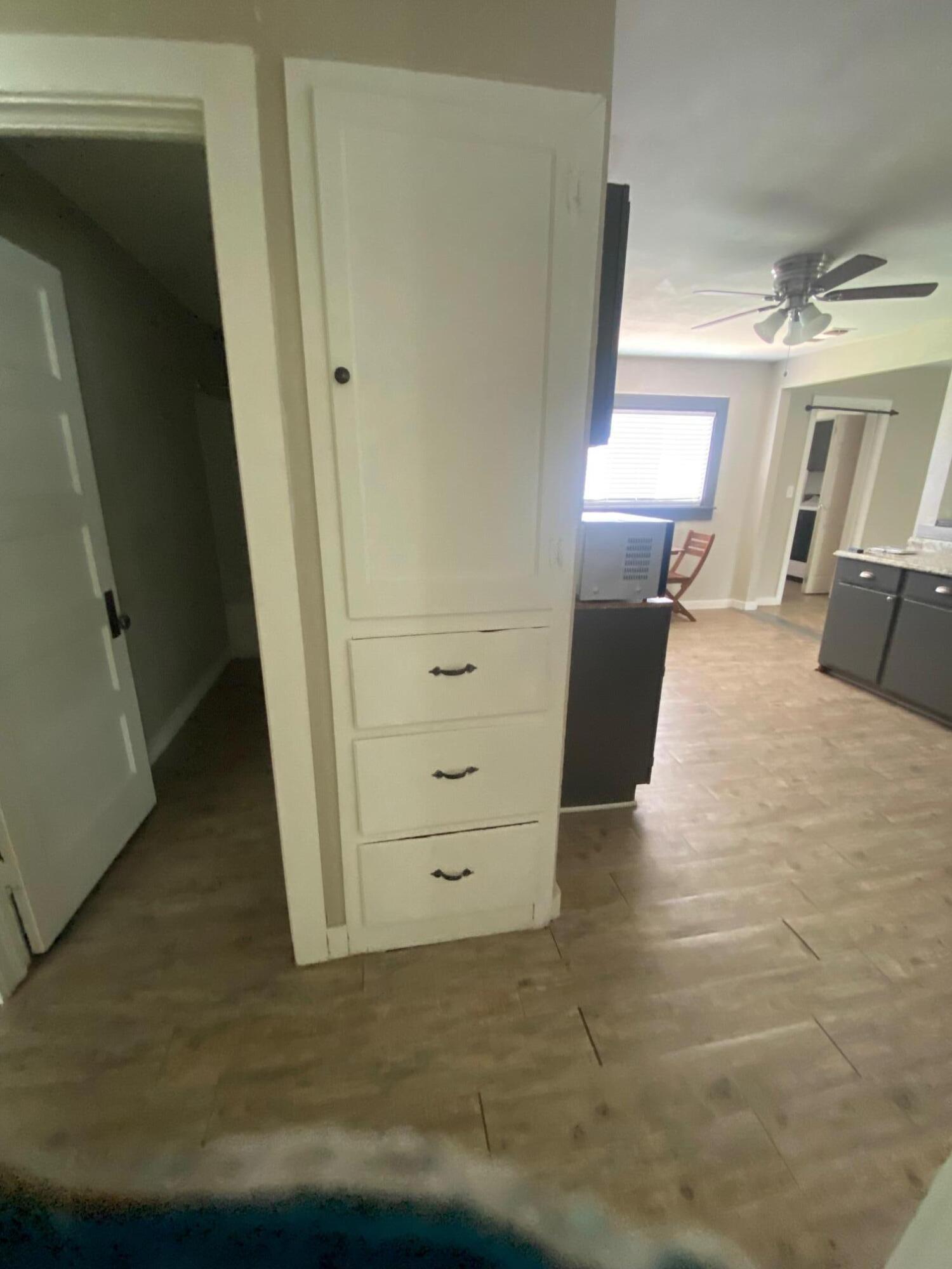 207 East 5th Street Sundown, TX 79372 - Photo 5 of 13 a view of a hallway with wooden floor and staircase