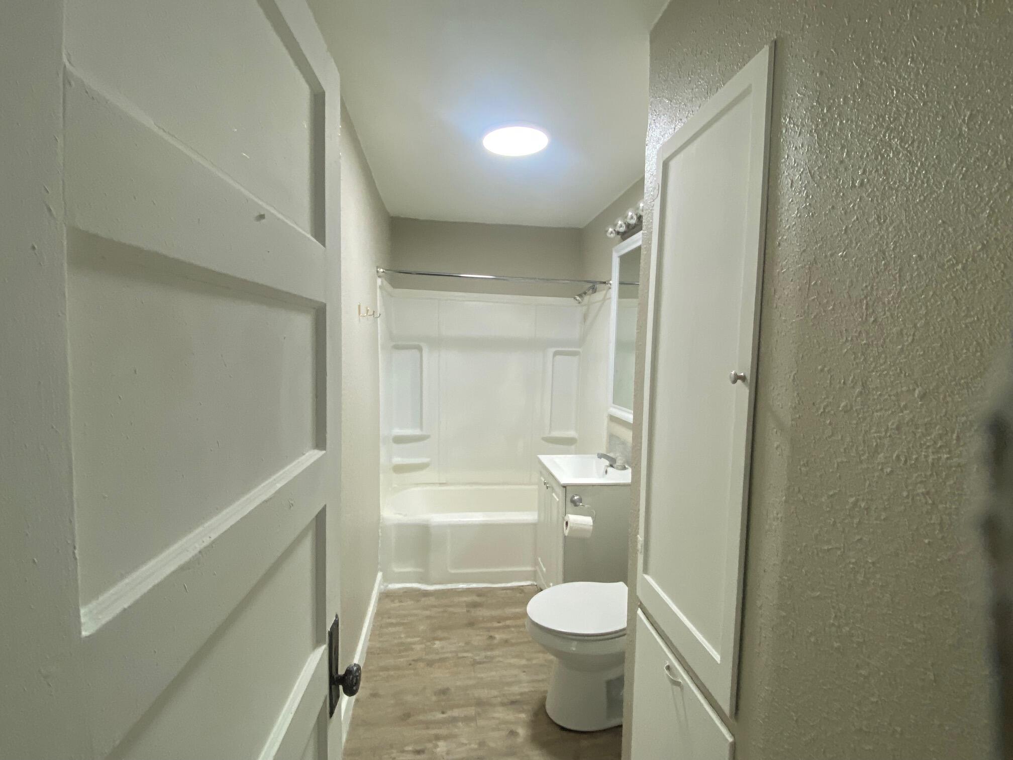 207 East 5th Street Sundown, TX 79372 - Photo 7 of 13 a bathroom with a toilet a sink and shower
