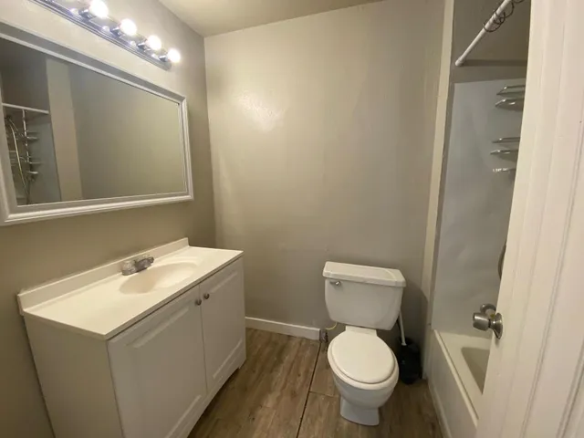a bathroom with a toilet sink and mirror