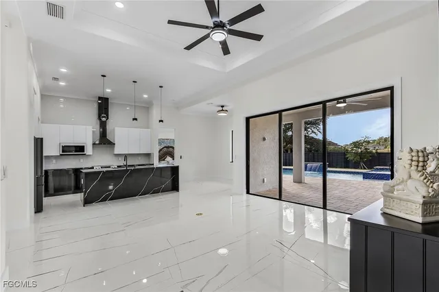 a view of a livingroom with a window and ceiling fan