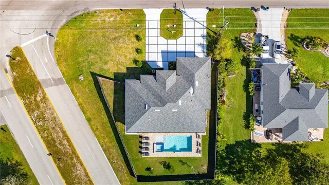 an aerial view of a house with a swimming pool