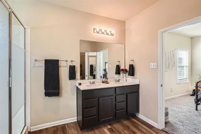 a bathroom with a double vanity sink and mirror