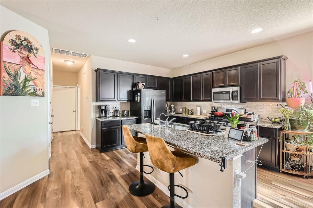 3013 Blantyre Bend Round Rock, TX 78664 - Photo 8 of 20 a kitchen with granite countertop lots of counter top space and stainless steel appliances