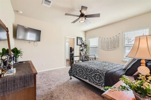 a bedroom with a bed dresser and mirror