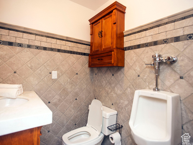 588 Raspberry Patch Road Garden City, UT 84028 - Photo 55 of 74 Half bath with tile walls, vanity, and a wainscoted wall