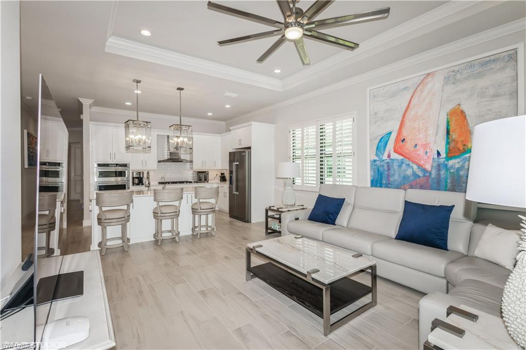 14605 Kingfisher Loop Naples, FL 34120 - Photo 12 of 42 a living room with furniture and kitchen view