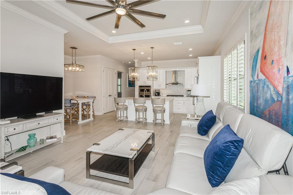 14605 Kingfisher Loop Naples, FL 34120 - Photo 13 of 42 a living room with furniture and a flat screen tv
