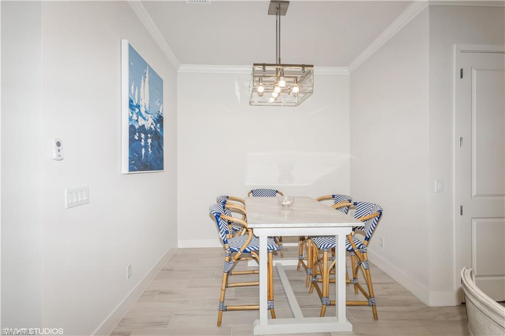 14605 Kingfisher Loop Naples, FL 34120 - Photo 17 of 42 a view of a dining room with furniture and wooden floor