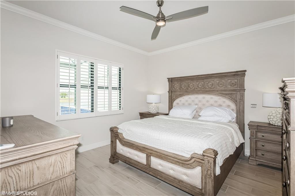 14605 Kingfisher Loop Naples, FL 34120 - Photo 19 of 42 a bedroom with a bed and a window