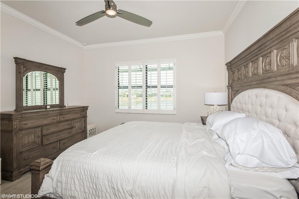 14605 Kingfisher Loop Naples, FL 34120 - Photo 20 of 42 a bedroom with a bed and a window
