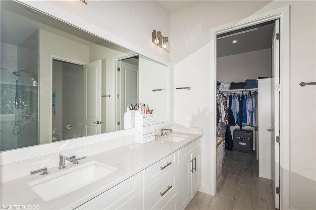 14605 Kingfisher Loop Naples, FL 34120 - Photo 21 of 42 a bathroom with a sink vanity and a mirror