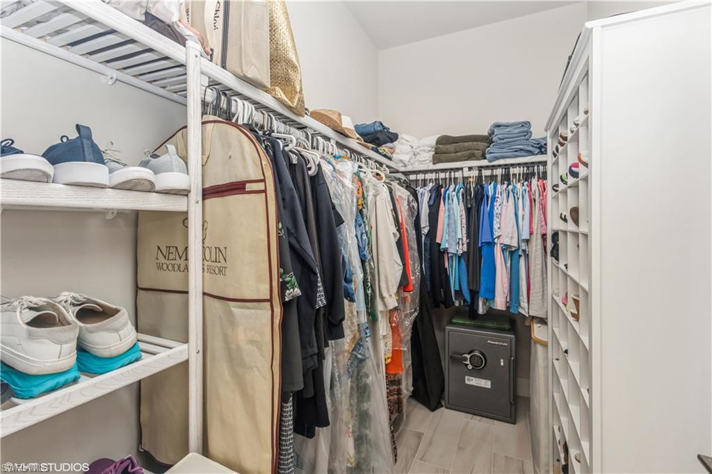14605 Kingfisher Loop Naples, FL 34120 - Photo 23 of 42 a view of walk in closet with clothes and shoes