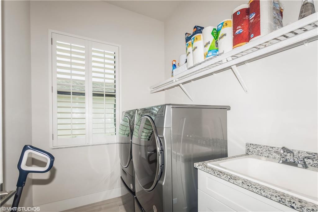 14605 Kingfisher Loop Naples, FL 34120 - Photo 28 of 42 a bathroom with a sink a toilet and a window