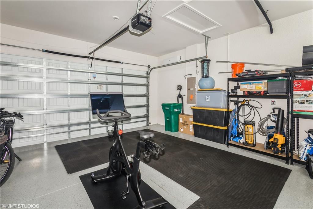 14605 Kingfisher Loop Naples, FL 34120 - Photo 29 of 42 a work room with furniture and a flat screen tv