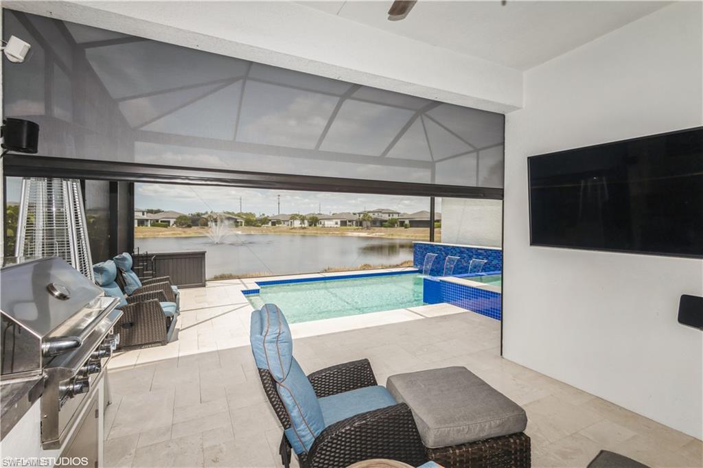 14605 Kingfisher Loop Naples, FL 34120 - Photo 30 of 42 a view of a dining room with furniture and a kitchen view