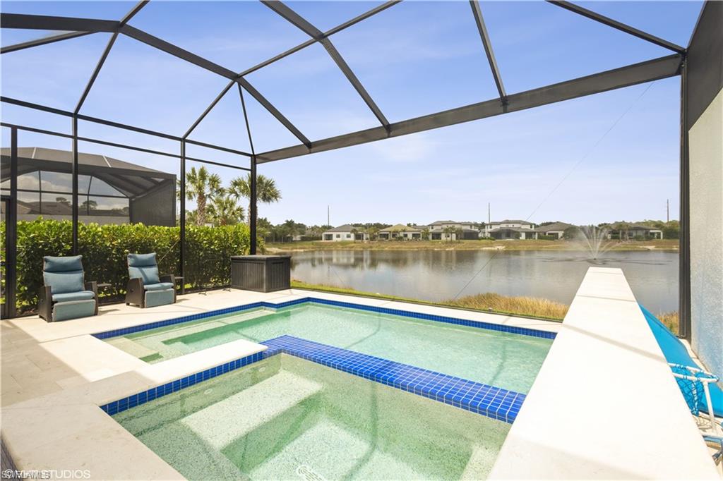 14605 Kingfisher Loop Naples, FL 34120 - Photo 33 of 42 a view of swimming pool with a patio and a yard