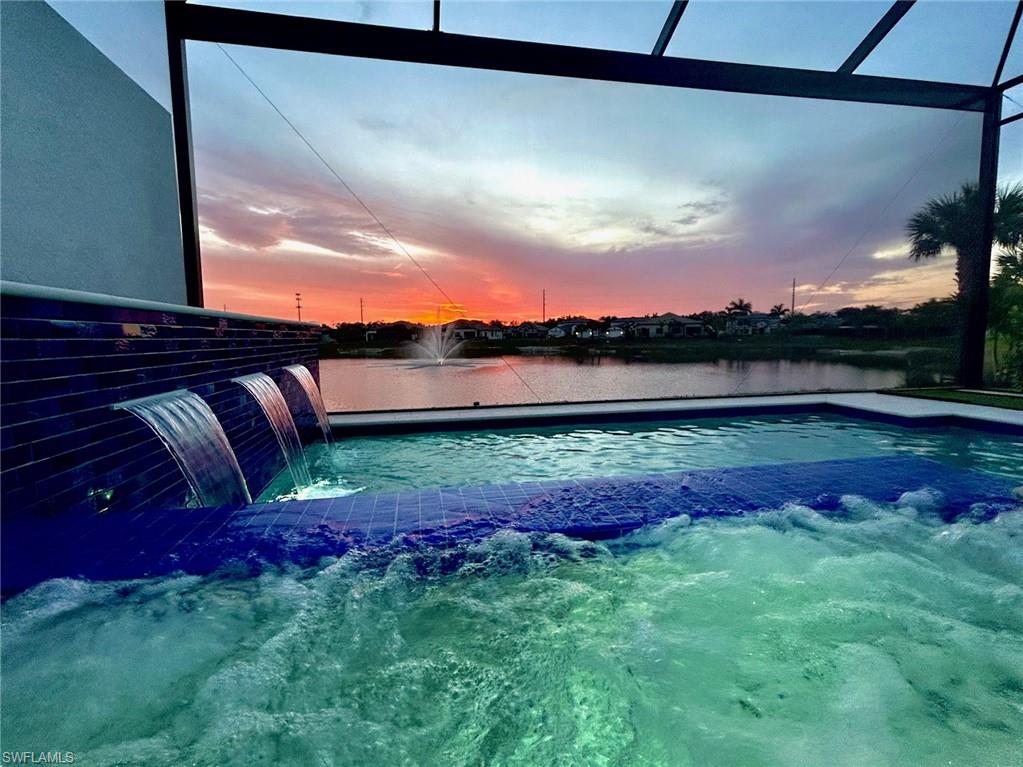 14605 Kingfisher Loop Naples, FL 34120 - Photo 36 of 42 a view of a yard with a swimming pool