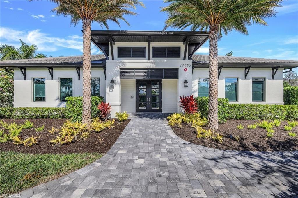 14605 Kingfisher Loop Naples, FL 34120 - Photo 38 of 42 a front view of a house with a garden