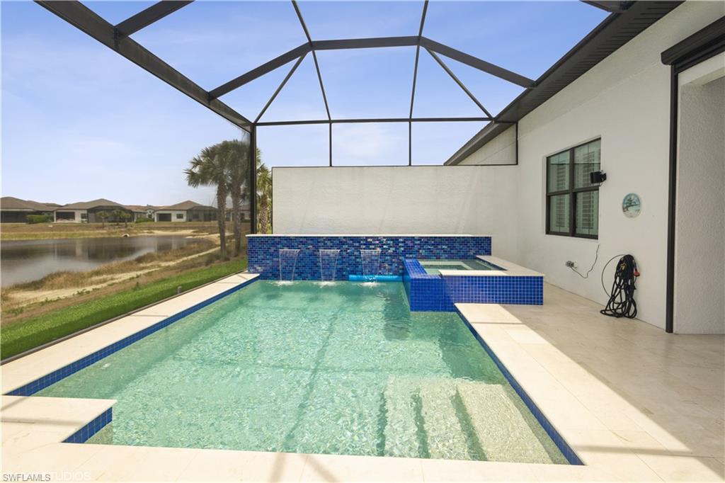 14605 Kingfisher Loop Naples, FL 34120 - Photo 4 of 42 a view of swimming pool with a yard