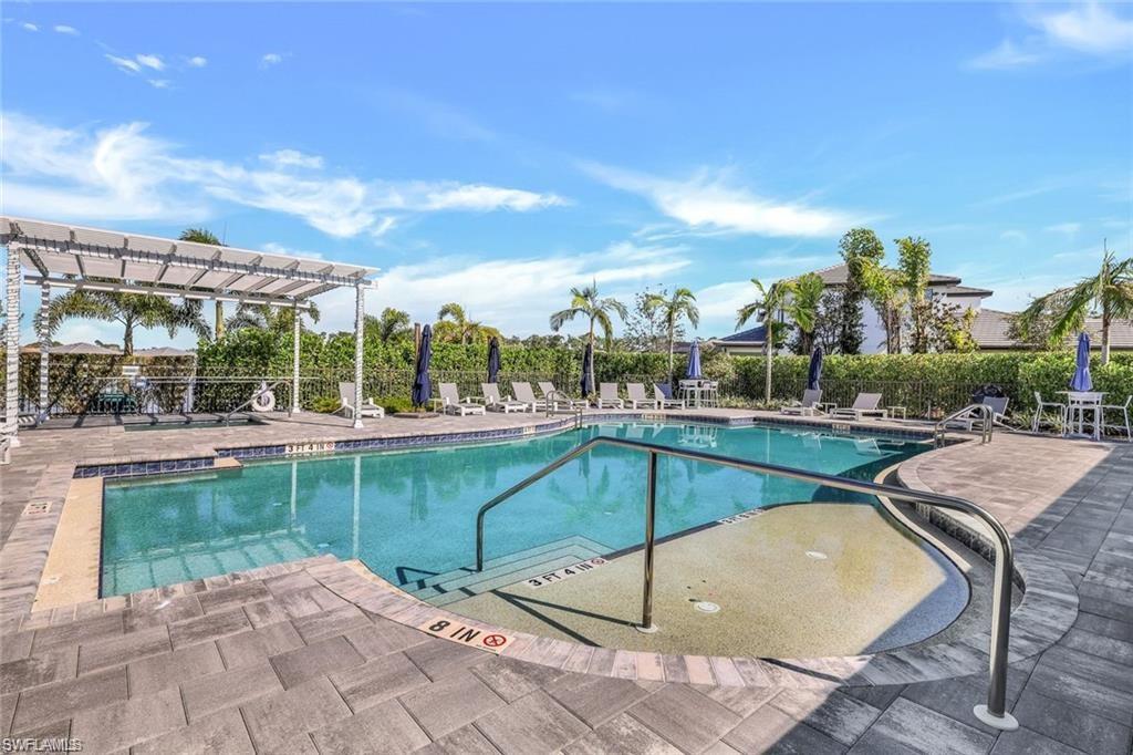 14605 Kingfisher Loop Naples, FL 34120 - Photo 40 of 42 a view of a swimming pool with a patio