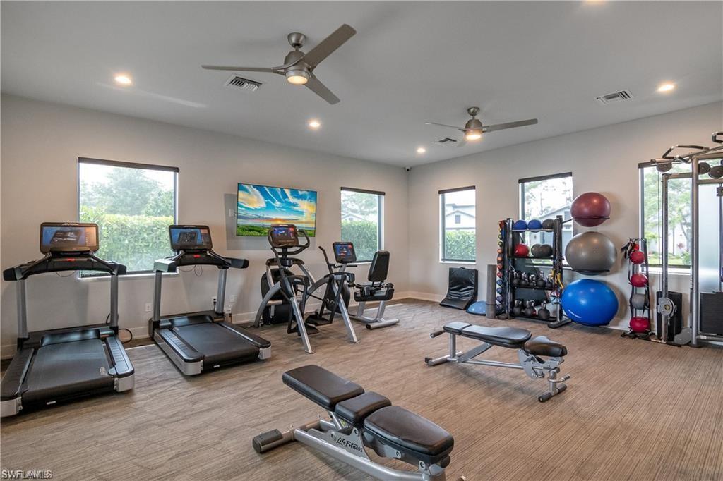 14605 Kingfisher Loop Naples, FL 34120 - Photo 41 of 42 a room with gym equipment and a large window