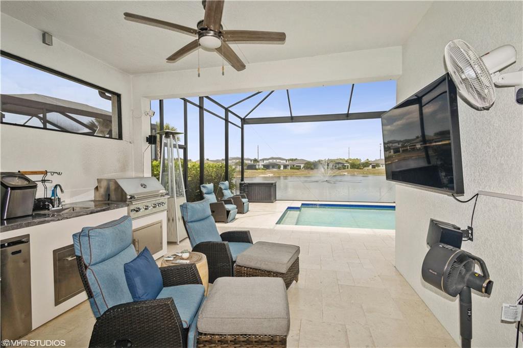14605 Kingfisher Loop Naples, FL 34120 - Photo 5 of 42 a living room with furniture and a flat screen tv