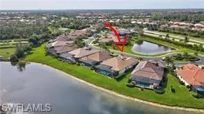an aerial view of a house with a garden and lake view