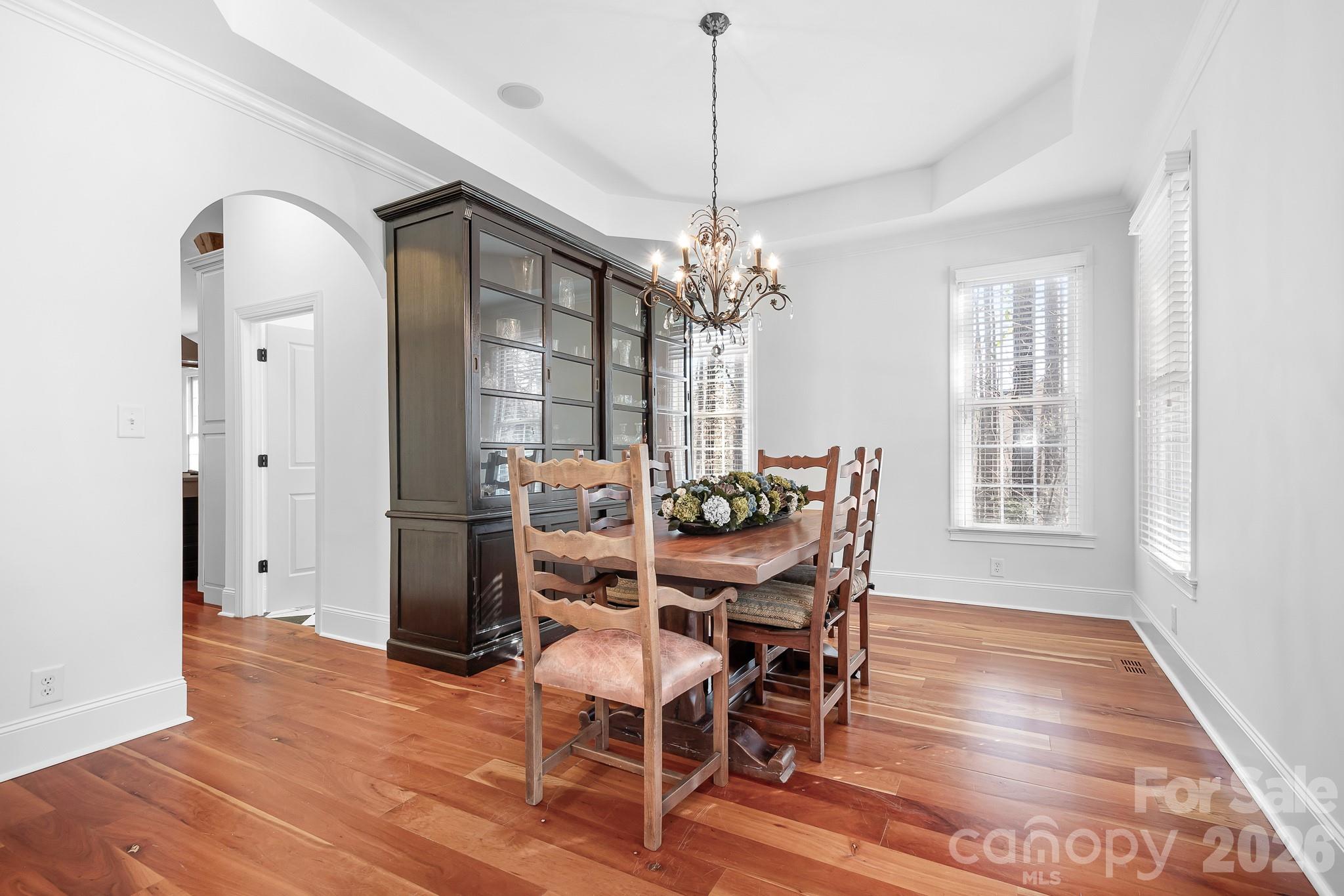 214 Lytham Lane Stanley, NC 28164 - Photo 11 of 46 a dining room with furniture a chandelier and wooden floor