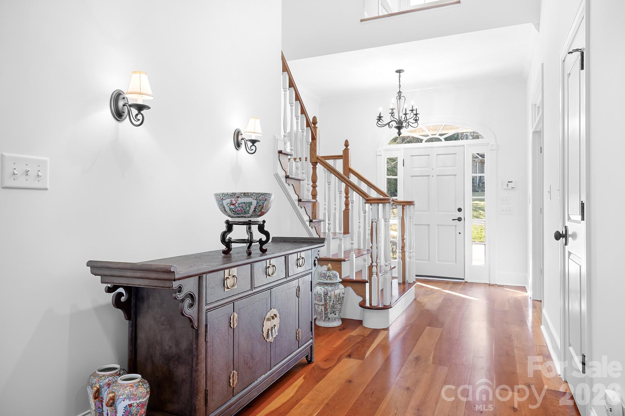 214 Lytham Lane Stanley, NC 28164 - Photo 12 of 46 a view of a hallway with wooden floor and staircase