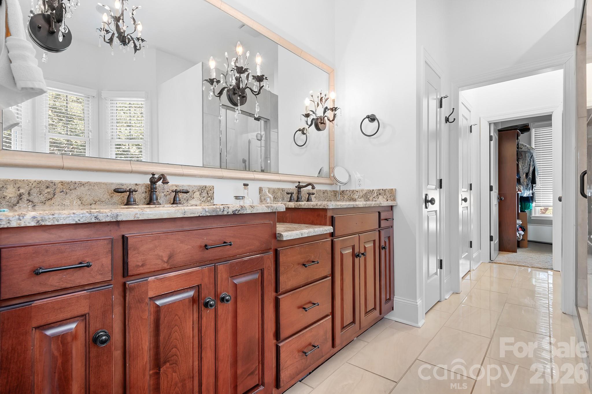 214 Lytham Lane Stanley, NC 28164 - Photo 17 of 46 a bathroom with a granite countertop sink a mirror and a shower