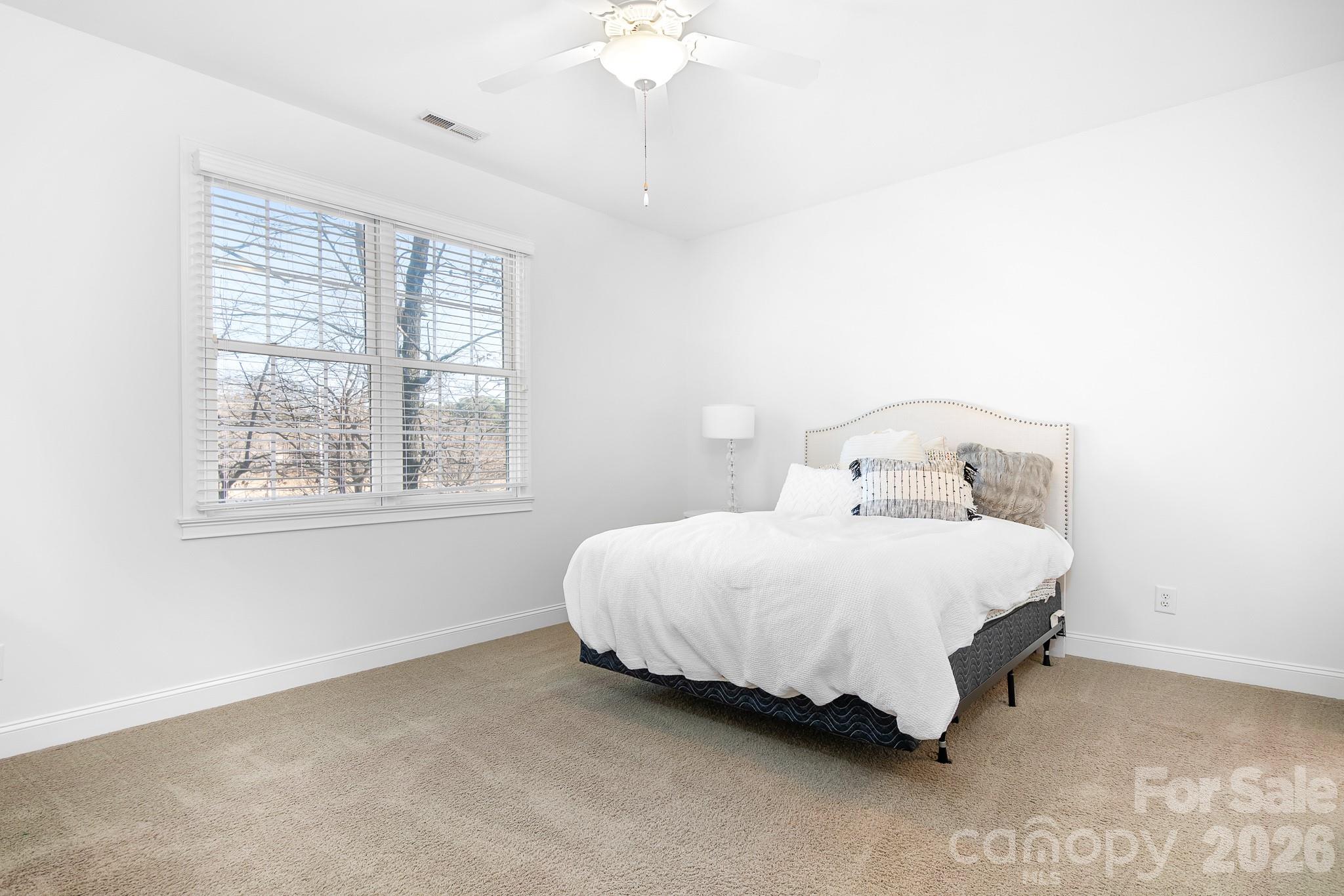 214 Lytham Lane Stanley, NC 28164 - Photo 19 of 46 a bedroom with a bed and a chandelier