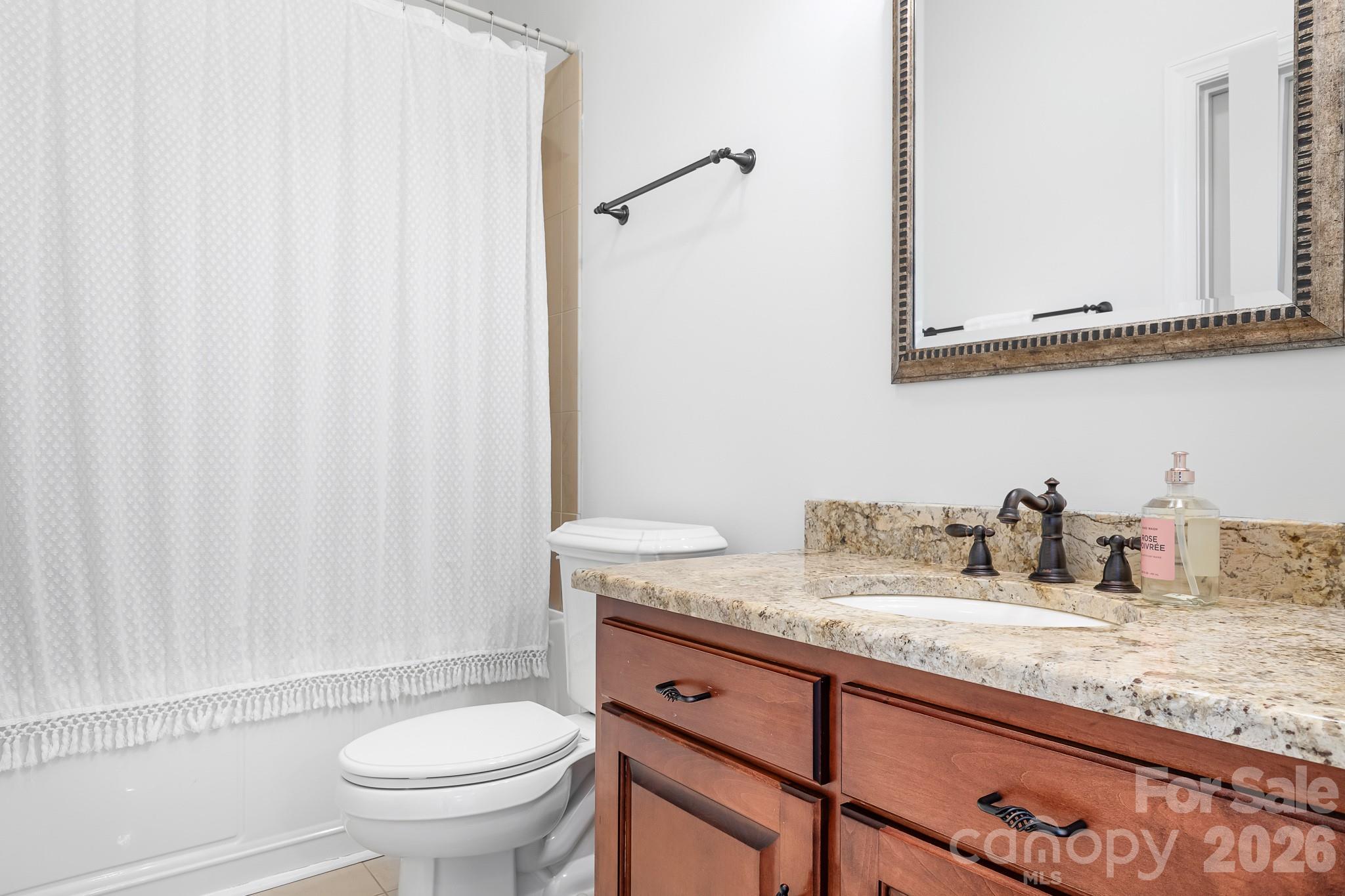 214 Lytham Lane Stanley, NC 28164 - Photo 24 of 46 a bathroom with a granite countertop sink and a mirror
