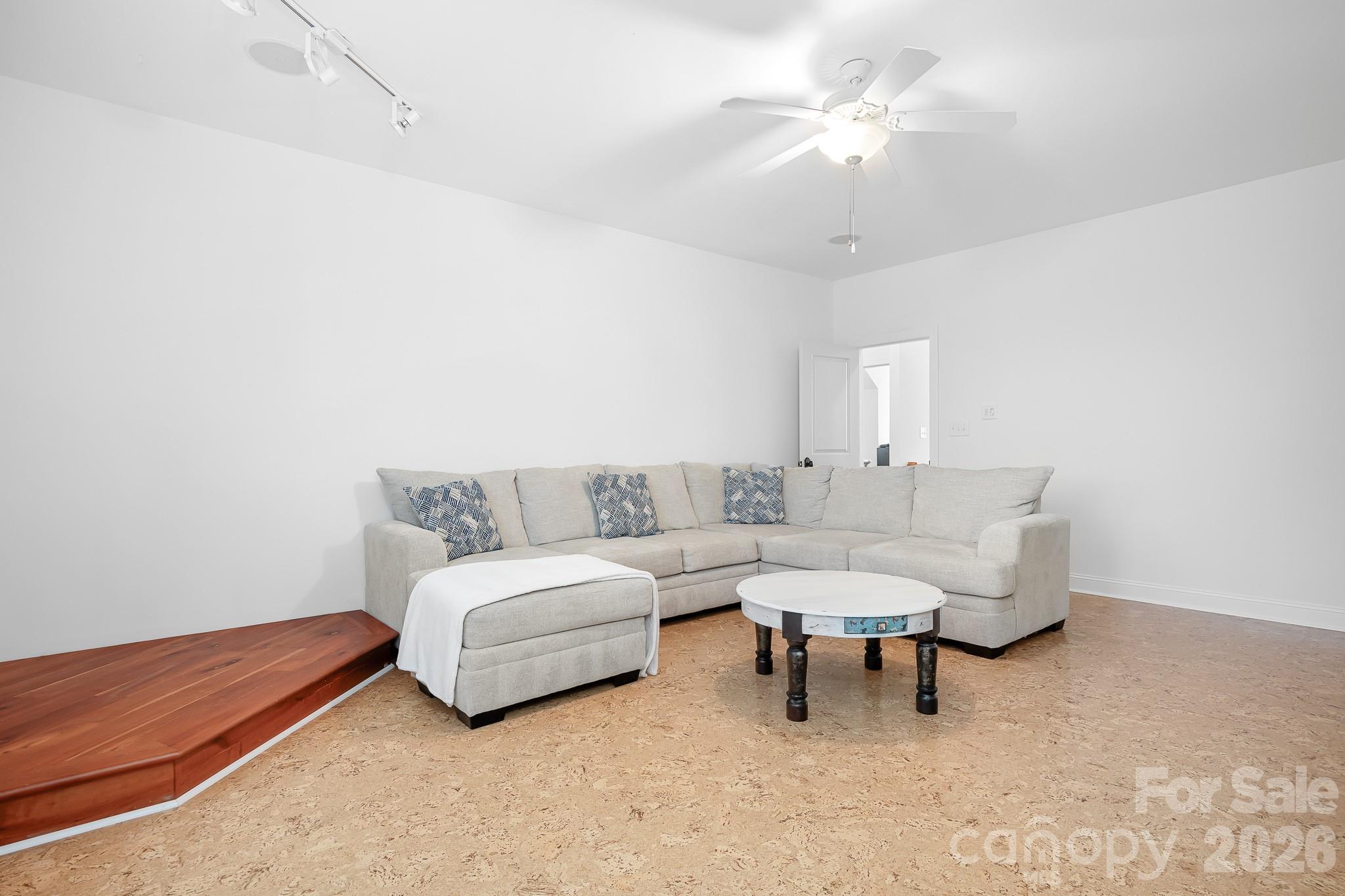214 Lytham Lane Stanley, NC 28164 - Photo 25 of 46 a living room with furniture and a chandelier