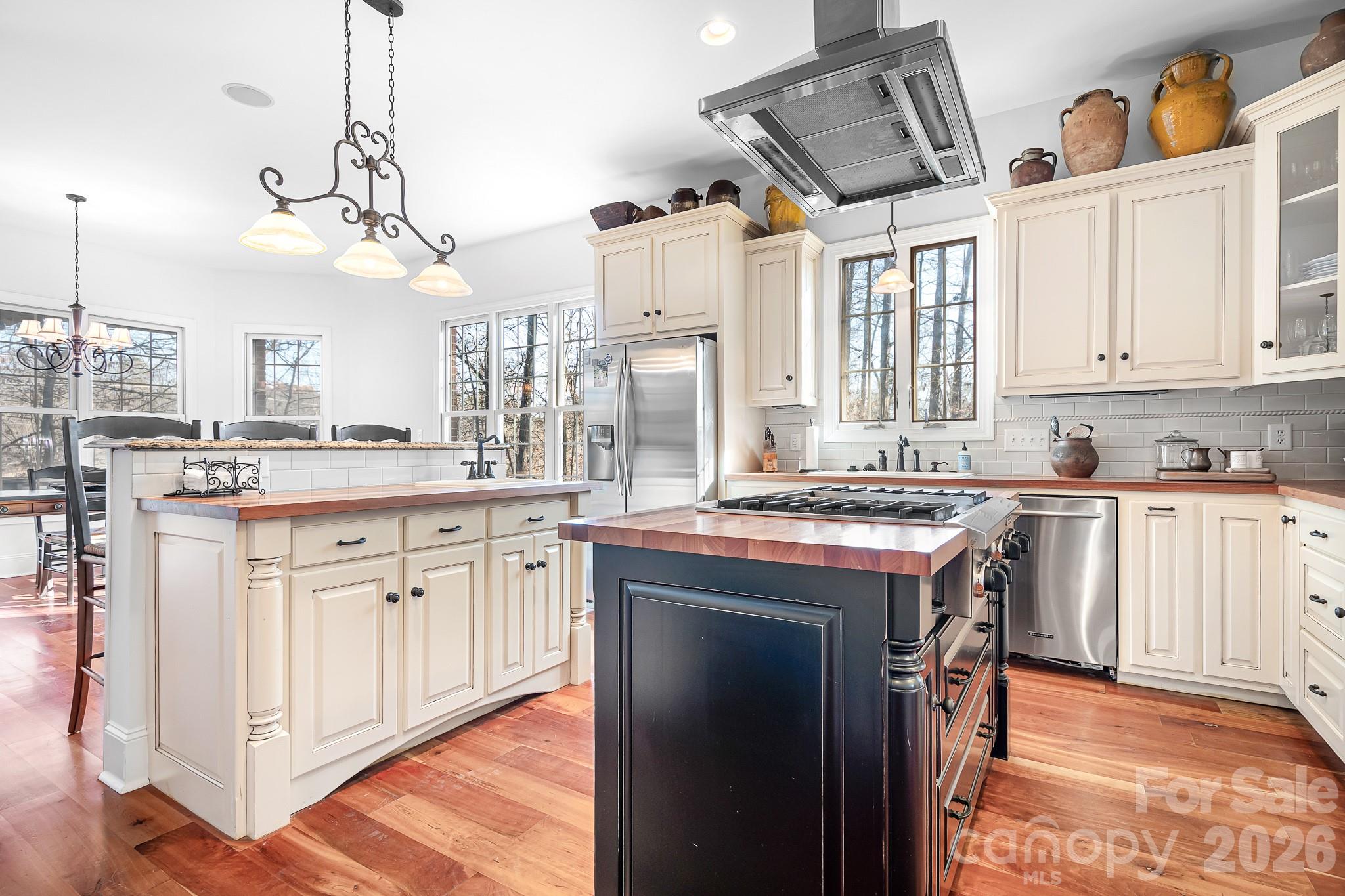 214 Lytham Lane Stanley, NC 28164 - Photo 5 of 46 a kitchen with stainless steel appliances granite countertop a stove a sink dishwasher and a refrigerator with wooden floor