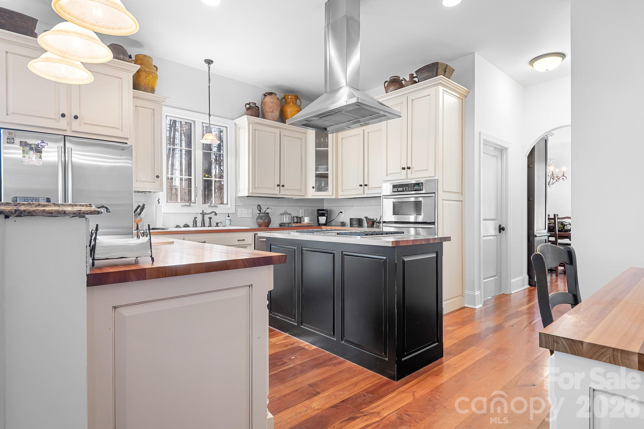214 Lytham Lane Stanley, NC 28164 - Photo 8 of 46 a kitchen with stainless steel appliances granite countertop a sink a stove and a refrigerator