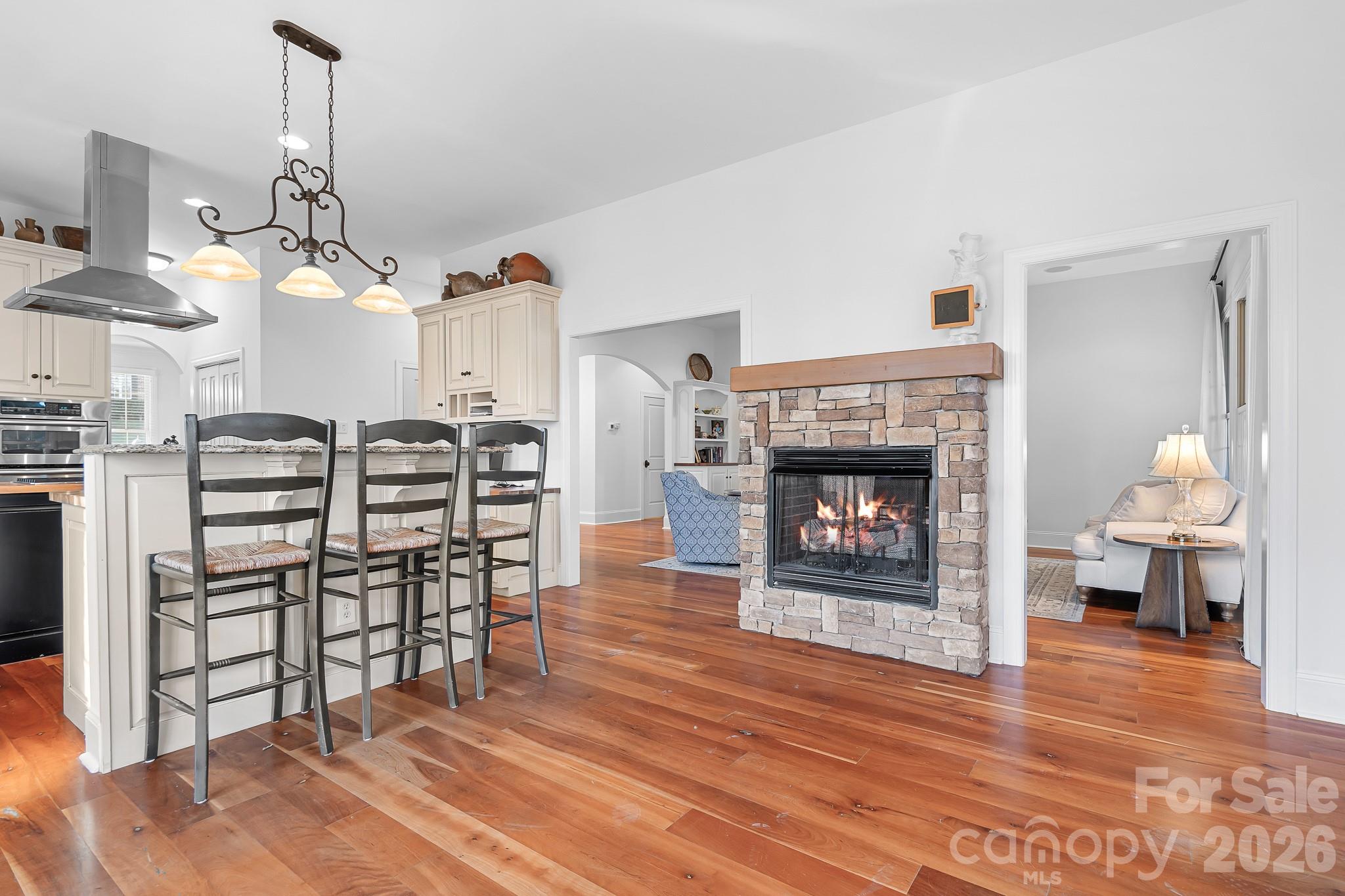 214 Lytham Lane Stanley, NC 28164 - Photo 9 of 46 a living room with furniture a fireplace and a chandelier
