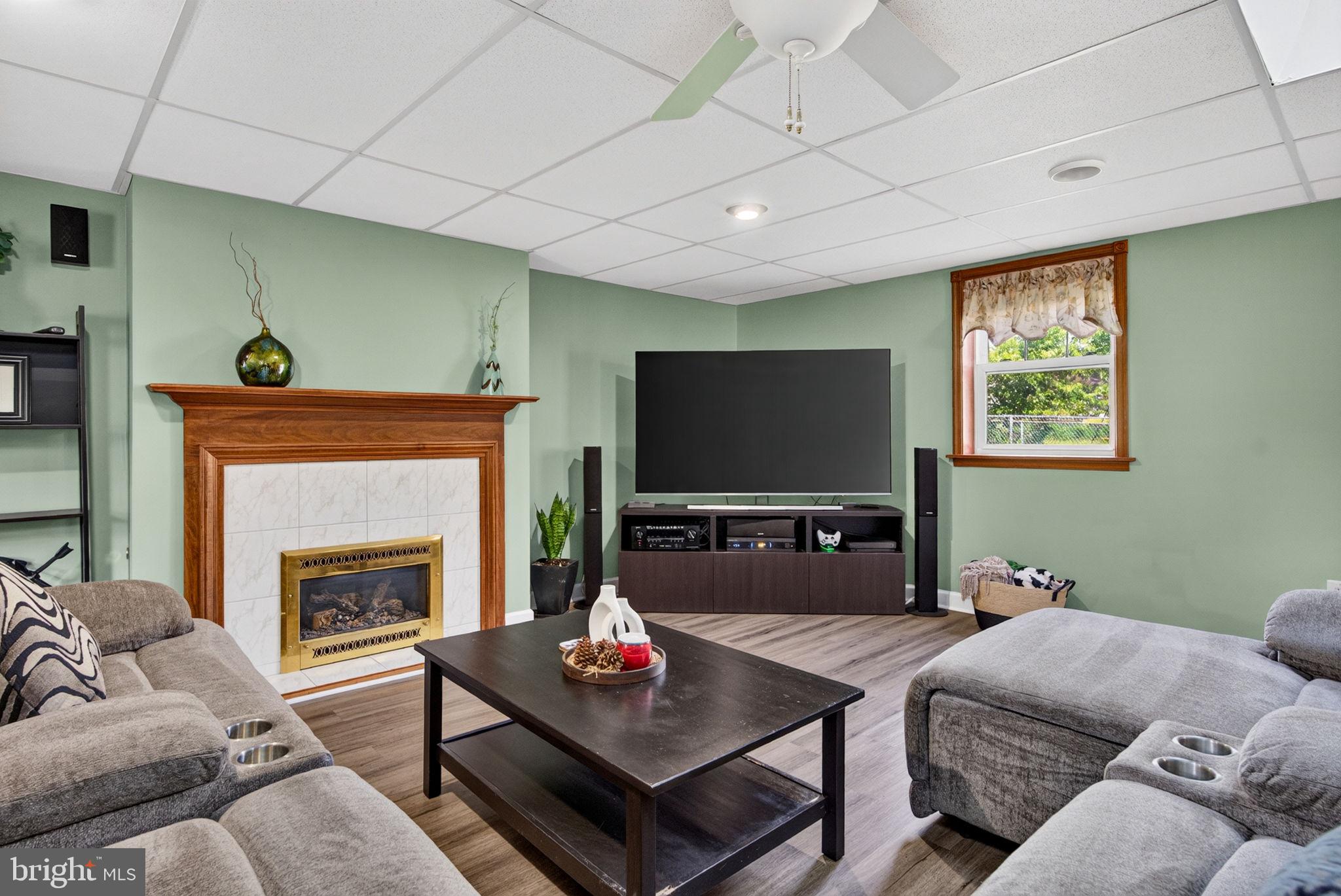 12 Woodbridge Road Gibbsboro, NJ 08026 - Photo 16 of 45 a living room with furniture a fireplace and a flat screen tv