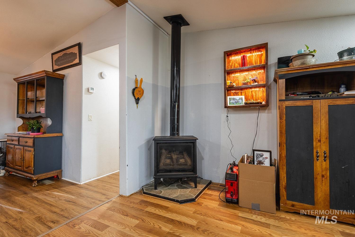 10 Reseda Ridge Circle Garden Valley, ID 83622 - Photo 11 of 28 Living room with a wood stove and light wood-style flooring