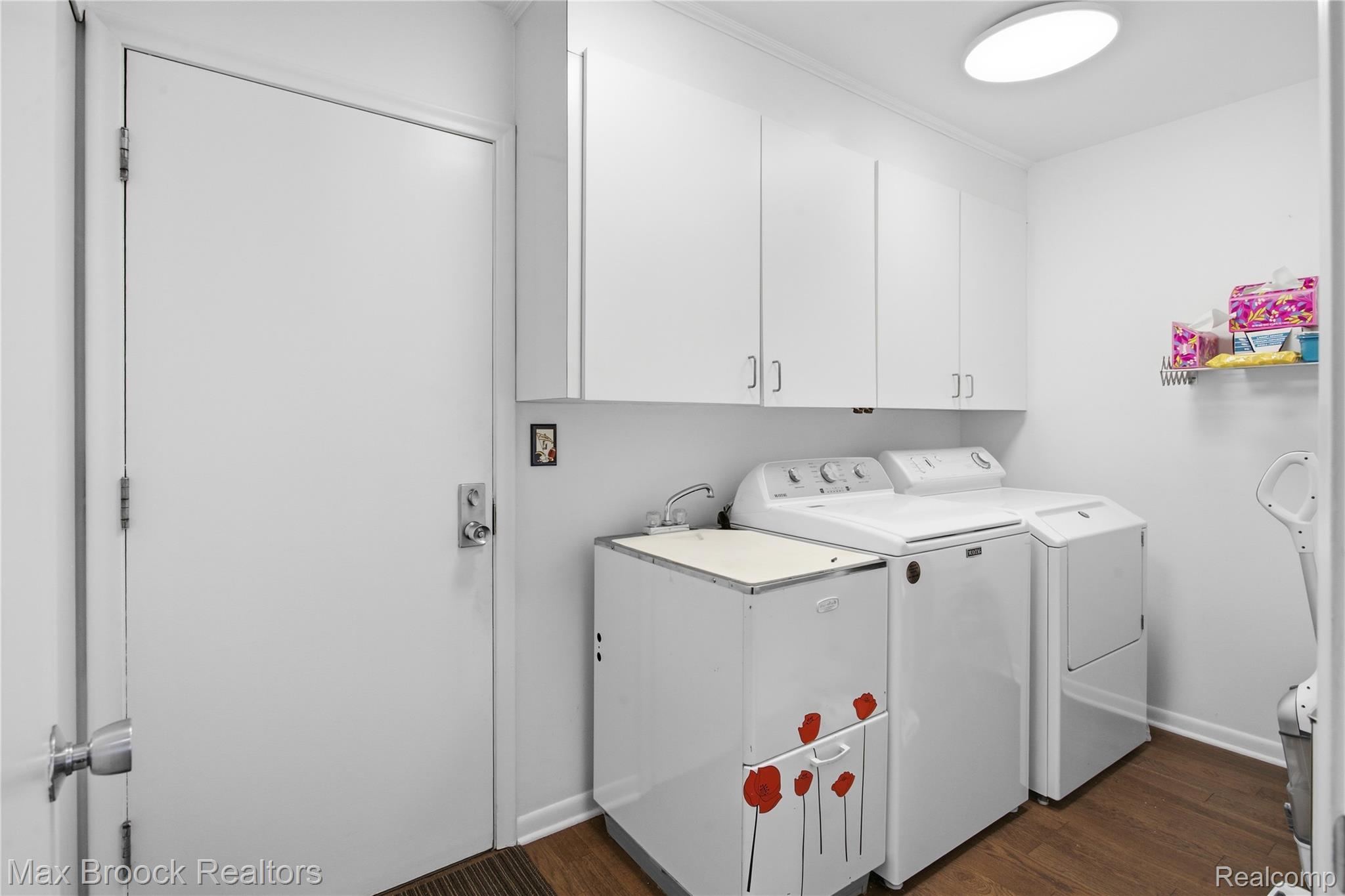7163 Suncrest Road West Bloomfield, MI 48322 - Photo 22 of 40 Laundry room featuring white cabinetry, a utility sink, and wood-finish flooring