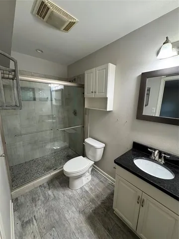 a bathroom with a sink toilet a mirror and shower