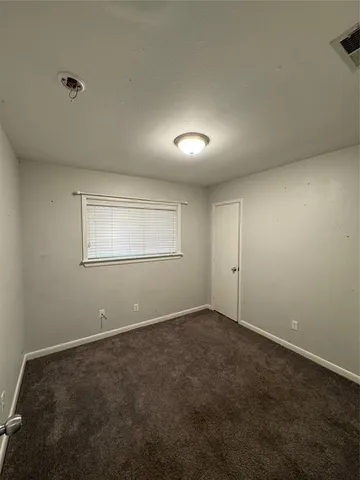 an empty room with a empty space and windows