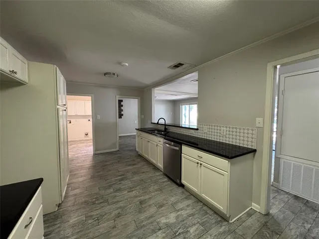 a kitchen with stainless steel appliances granite countertop a stove and a refrigerator