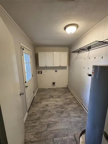 a view of a kitchen with white cabinets and wooden floor