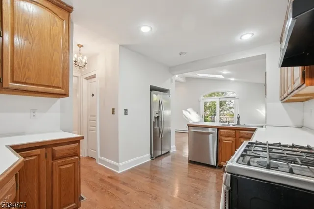 a kitchen with stainless steel appliances granite countertop a stove a sink and a refrigerator