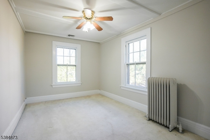 4 Fairwood Road Madison, NJ 07940 - Photo 25 of 38 an empty room with windows and chandelier fan