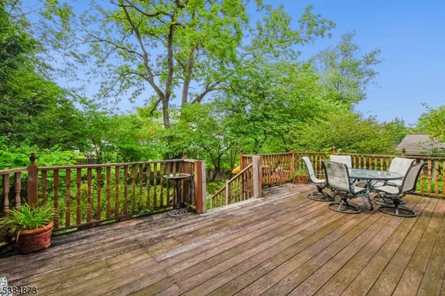 a view of a deck with two chair and wooden floor