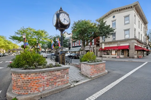 a front view of a house with a yard and outdoor seating
